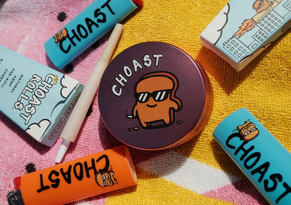 beach-towel-sesh-accesories Our choast smoke accessories laying on a colorful beach towel. Showing our different products which are; choast pre roll cones, the choast grinder, and our choast lighters.