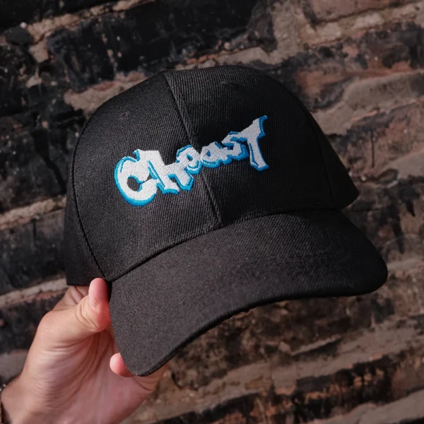 Our GraffCap being held up showing the front graffiti lettering spelling choast.